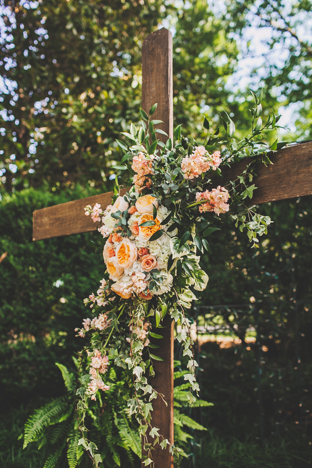 Cross floral backdrop for ceremony. | Floral Design: Enchanted Florist